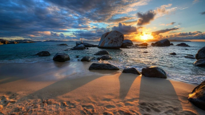 body of water near rock formation nature sea beach sunset 2k