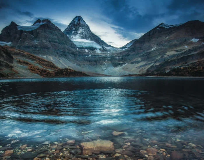 body of water lake surrounded by mountains forest fall snowy peak 2k