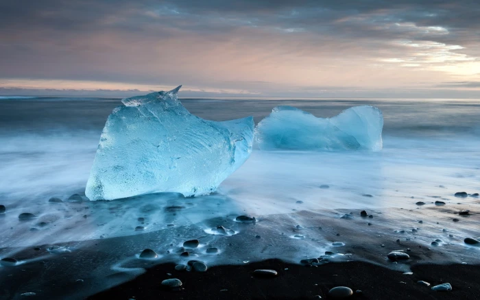 ice on body of water iceberg beach sky stones landscape 2k