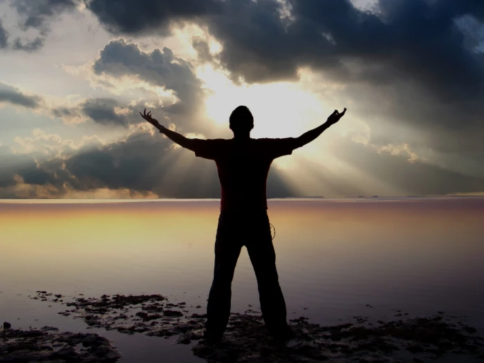 man standing in front of a body water Rays Wonder Sun Light 2k