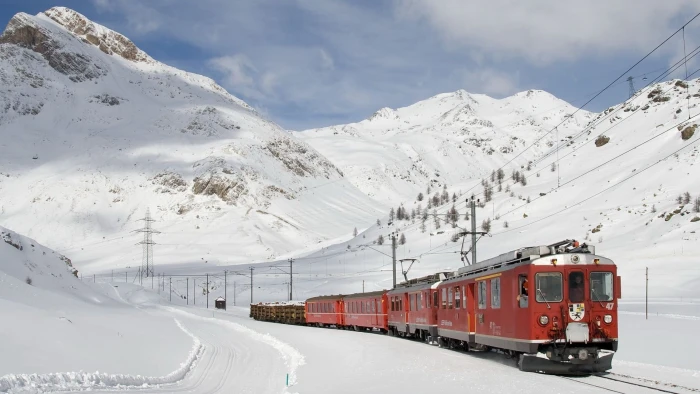 red train on trail covered with snow during daytime nature landscape 2k