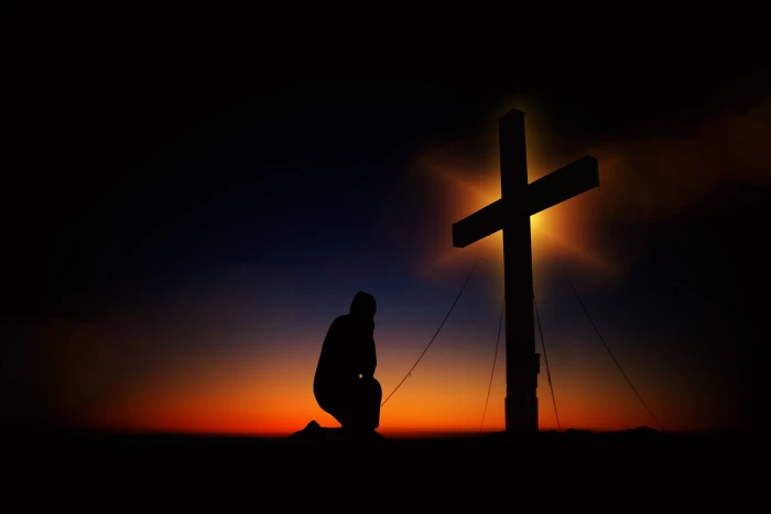 silhouette of man kneeling in front a cross sunset humility 2k 4k 5k