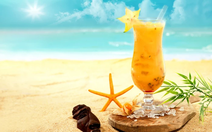 tropics beach sand sea cocktail thailand bali vietnam yellow beverage in clear parfait glass 2k
