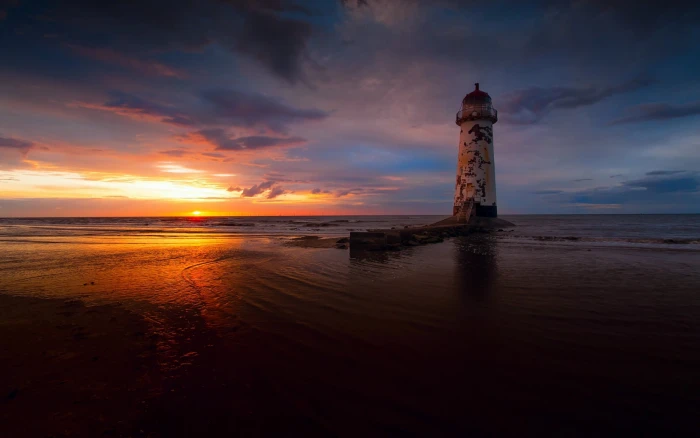 landscape photography of lighthouse during sunset beach sea 2k