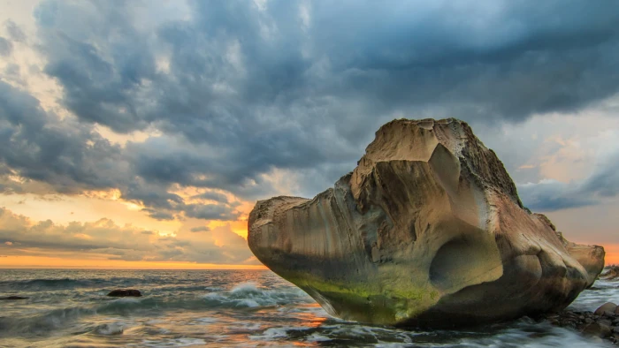 landscape photography of rock formation on body water during golden hour fangshan