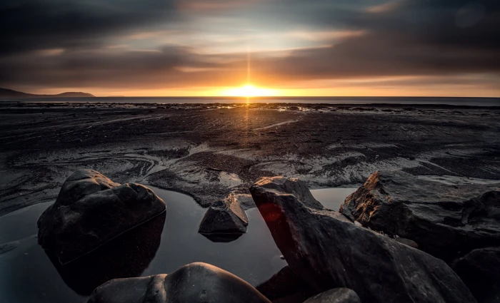 body of water landscape sunset sea beach rocks sky nature 2k