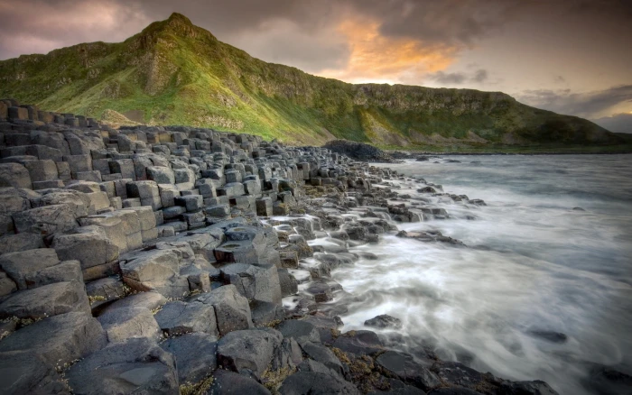 gray concrete beside ocean near mountain at daytime nature landscape 2k