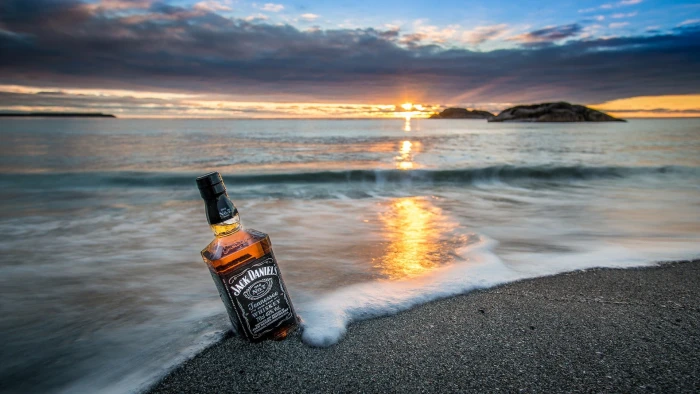 horizon waves rock nature landscape sunrise sand bottles reflection sea clouds island coast beach whiskey Jack Daniels 2k