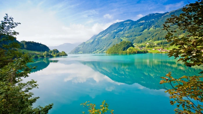 landscape photography of body water surrounded with mountains 2k