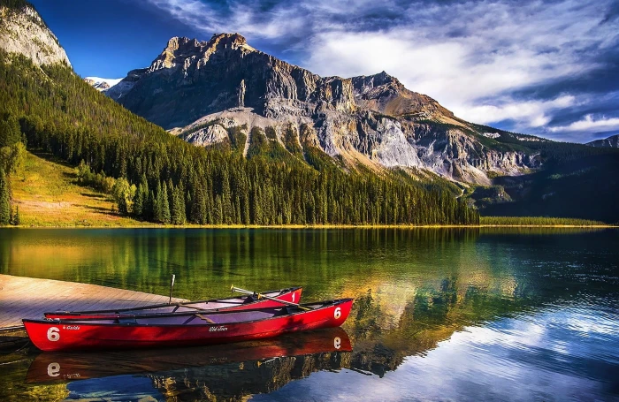 two red kayaks landscape nature lake mountains forest canoes