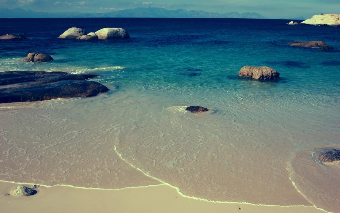 white sandy beach sea rocks coast tropical island water 2k