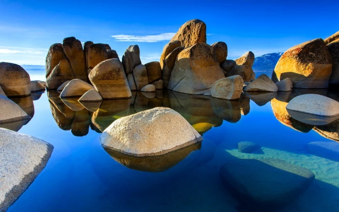 brown rock formation nature landscape water sea stones clouds 2k