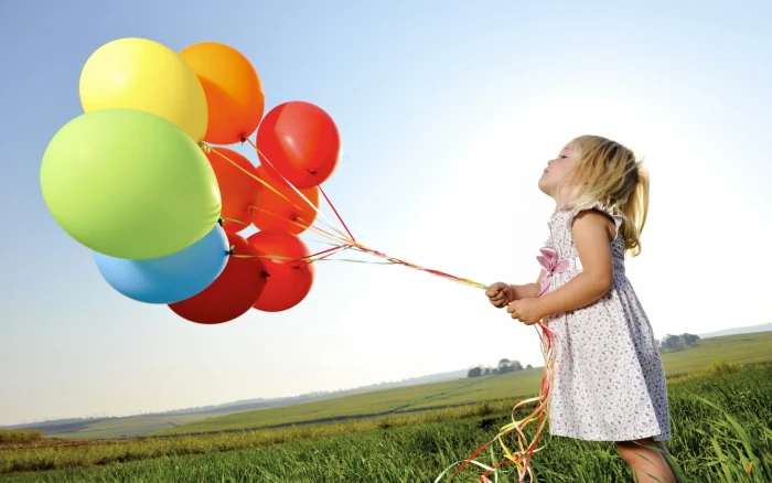 girl in white dress holding assorted color balloons little 2k