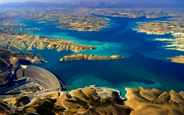 aerial view of mountains surrounding water and dam lake Turkey 2k