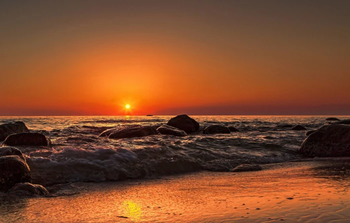 rocks on body of water sea Sun beach waves nature sky sunset 2k