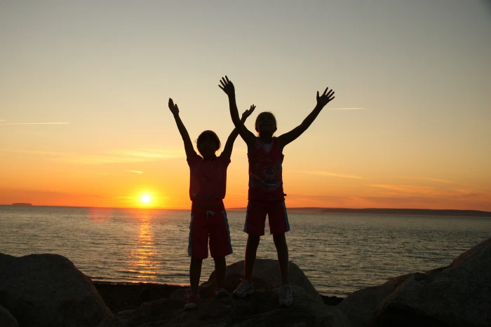 two person standing on rock beside ocean silhouette photo children 2k 4k