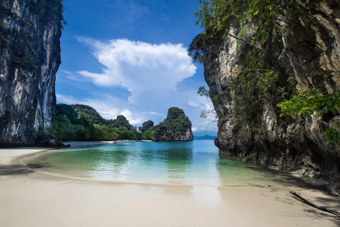 gray rock cliff landscape nature white sand beach sea boat 2k