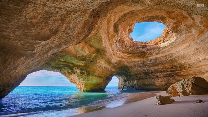 landscape photography of cave sea shore nature beach rock object 2k