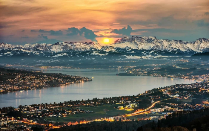 aerial photography of mountain with body water view sun on mountains 2k