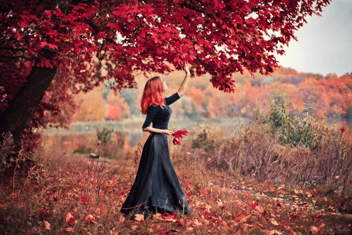 women s black dress woman in quarter sleeved long picking red trees leaf during daytime 2k