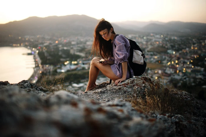 women s pink long sleeved dress photography of woman sitting on gray rock 2k