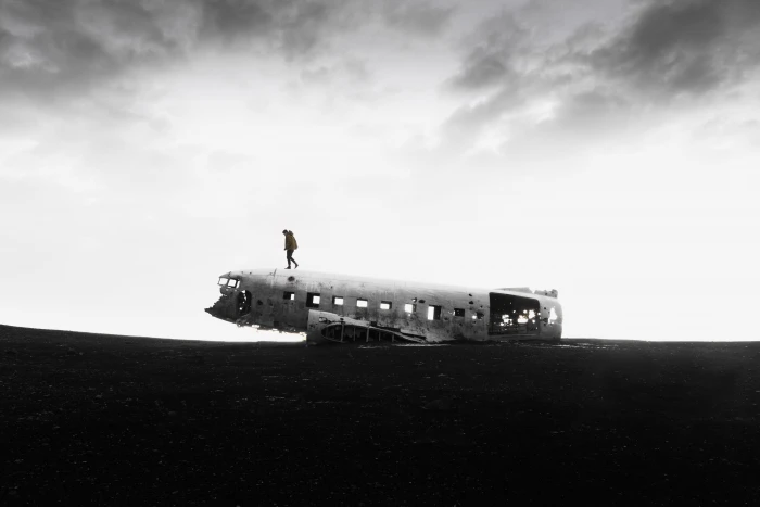 Get Lost and Find Yourself grayscale photography of person walking on crashed plane part open field 2k 4k 5k