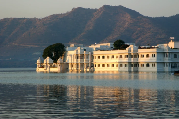 white concrete building near body of water udaipur india rajasthan 2k