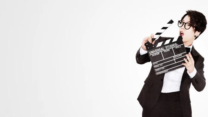 man in black suit jacket holding clapboard Blockb Taeil 2k