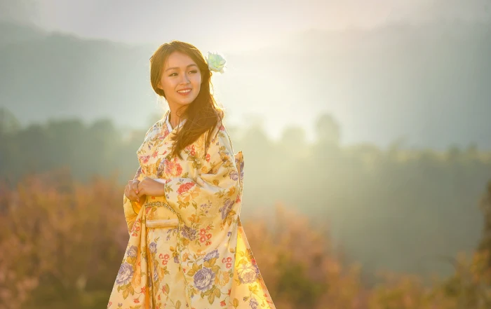 selective focus photography of woman wearing yellow and green floral long sleeved traditional dress 2k 4k