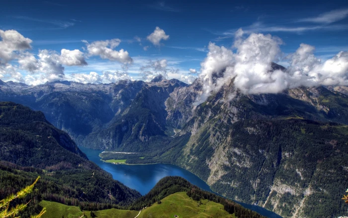 body of water in between green mountains nature river clouds 2k