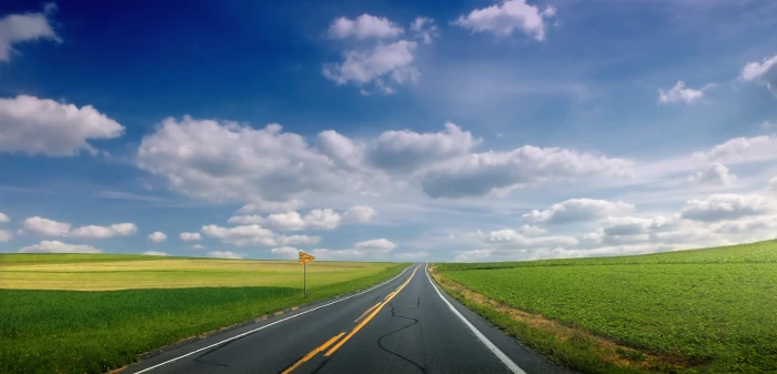 empty road between green grass under white and blue cloudy sky 2k 4k 5k