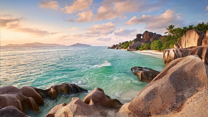 body of water and brown rocks landscape nature tropical island 2k