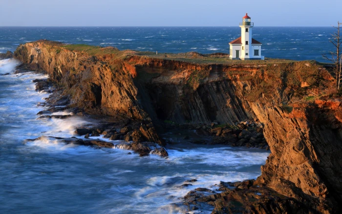 Cape Arago Lighthouse beach coast cliffs Pacific white light house on cliff beside ocean 2k
