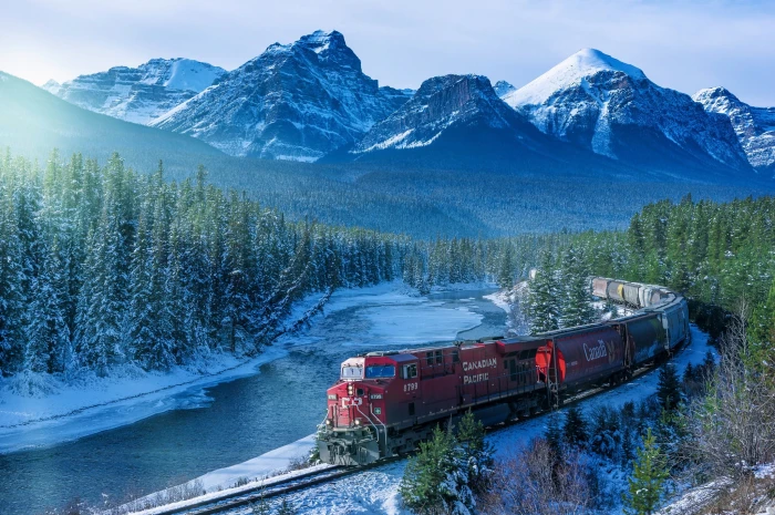 red train on rail photography Canada landscape mountains 2k