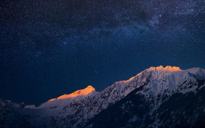 Milky Way galaxy visible in the night sky snow covered mountain 2k