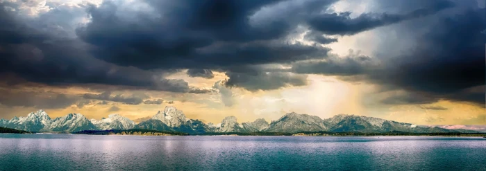 panoramic photography of mountains near body water during cloudy day 2k 4k 5k