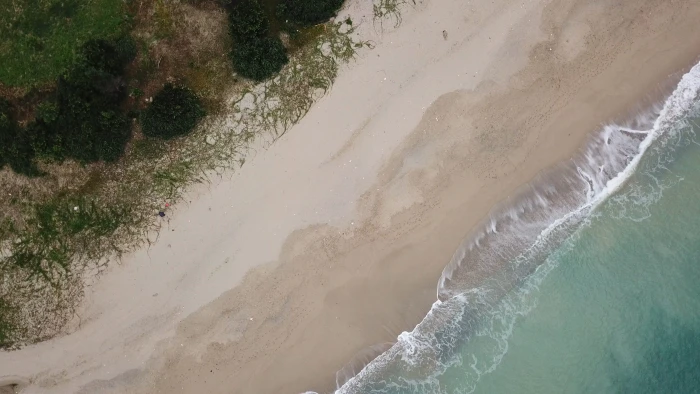 top view photography of ocean water and beach sand aerial 2k 4k