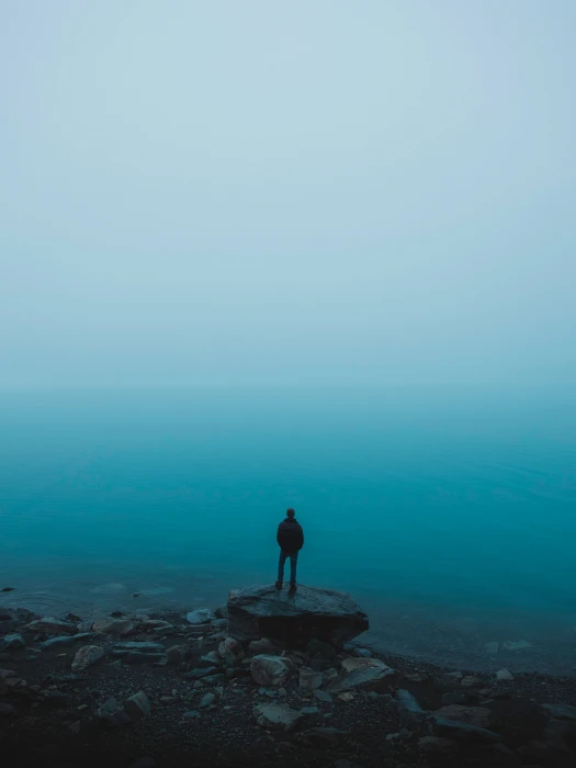 brown boulder man sea stones loneliness alone nature hiking 2k 4k