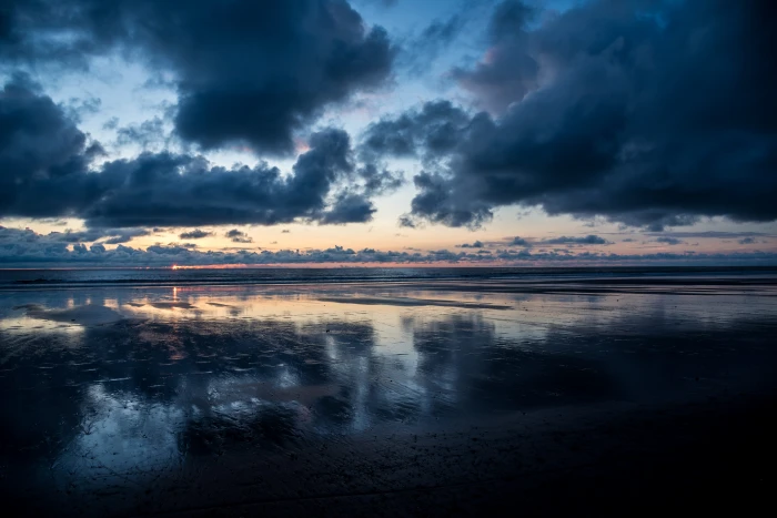 calm body of water under dark clouds cloudy sky 2k 4k 5k