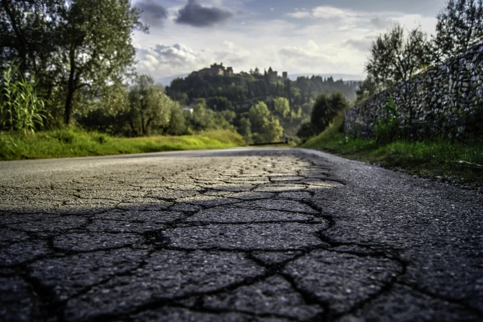gray asphalt road with crack tuscany italy italian field 2k 4k