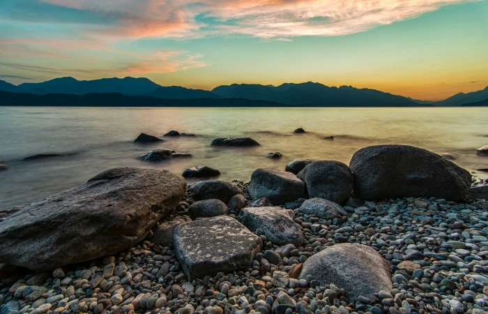brown rocks bear body of water during sunset Colors Background 2k 4k 5k
