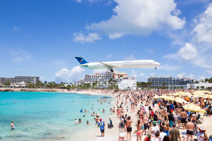 group of people at beach with white airliner background airplane 2k 4k 5k