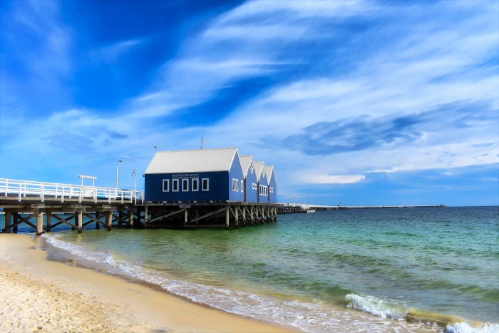 blue house at the beach during daytime water sea sand sky 2k 4k 5k