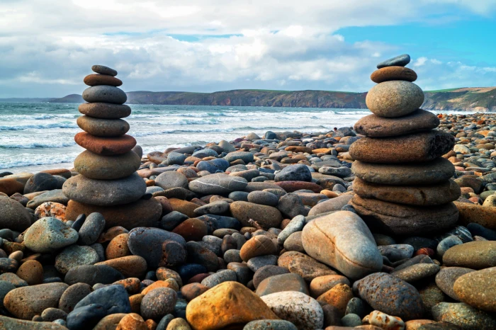 low angle photography of two piles stones near seashore during daytime 2k 4k 5k