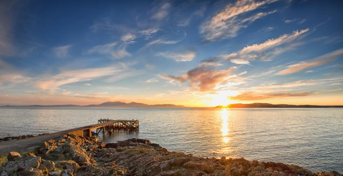 brown wooden dock over viewing wide ocean at sunset Portencross 2k 4k 5k