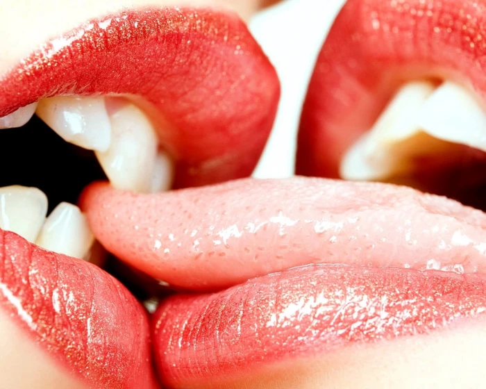 human tongue kiss lips biting play red lipstick close up