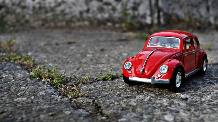 red Volkswagen Beetle scale model car toys closeup macro 2k