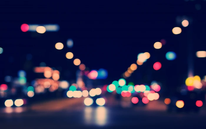 assorted color bokeh lights photography of vehicle on road 2k 4k