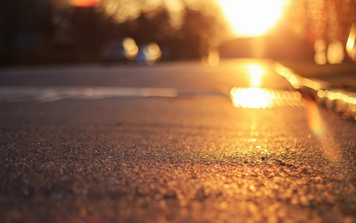 gray pavement asphalt the sun macro rays background earth 2k