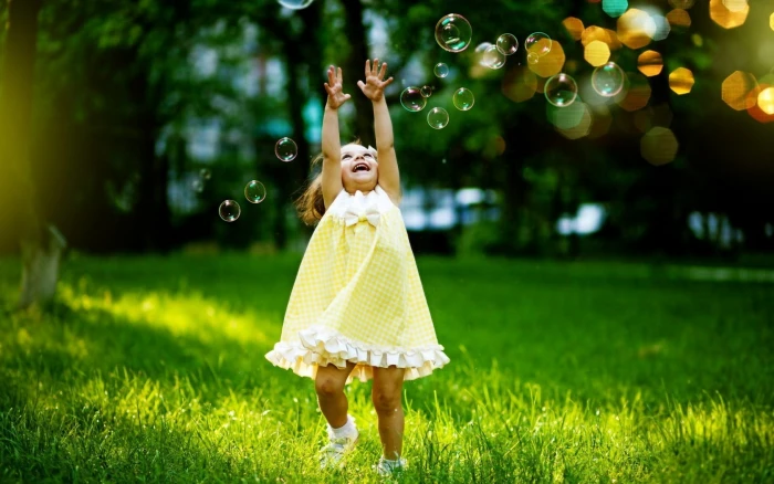 little girl happiness bubbles grass bokeh trees one person 2k